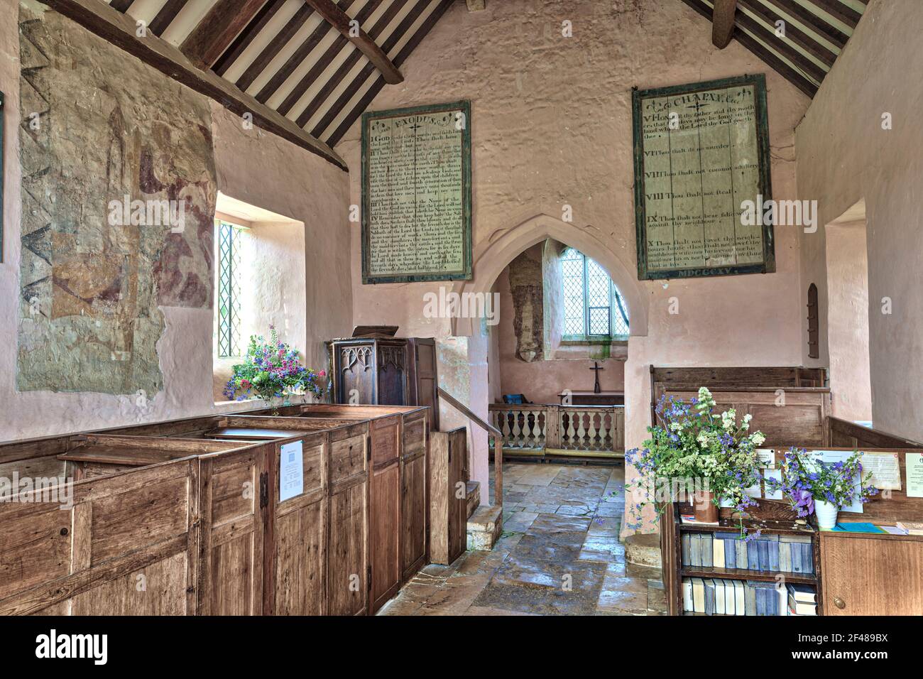 The interior of the 13th century church of St Oswald, now isolated, standing on the edge of a deserted medieval village at Widford, Oxfordshire UK Stock Photo