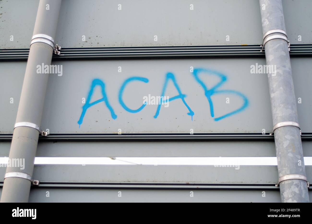 Aylesbury, UK. 15th March, 2021. All Cops Are Bastards ACAB graffiti on signs near the Spinney where HS2 Ltd have felled most of the trees in there om Small Dean Lane near Wendover, Aylesbury as well as a beautiful hazel coppice. Local residents are heart broken to see the destruction that HS2 is causing around Wendover and Aylesbury. High Speed Rail 2 are carving a huge scar across the Chilterns which is an AONB for the controversial rail link from London to Birmingham. . Credit: Maureen McLean/Alamy Stock Photo