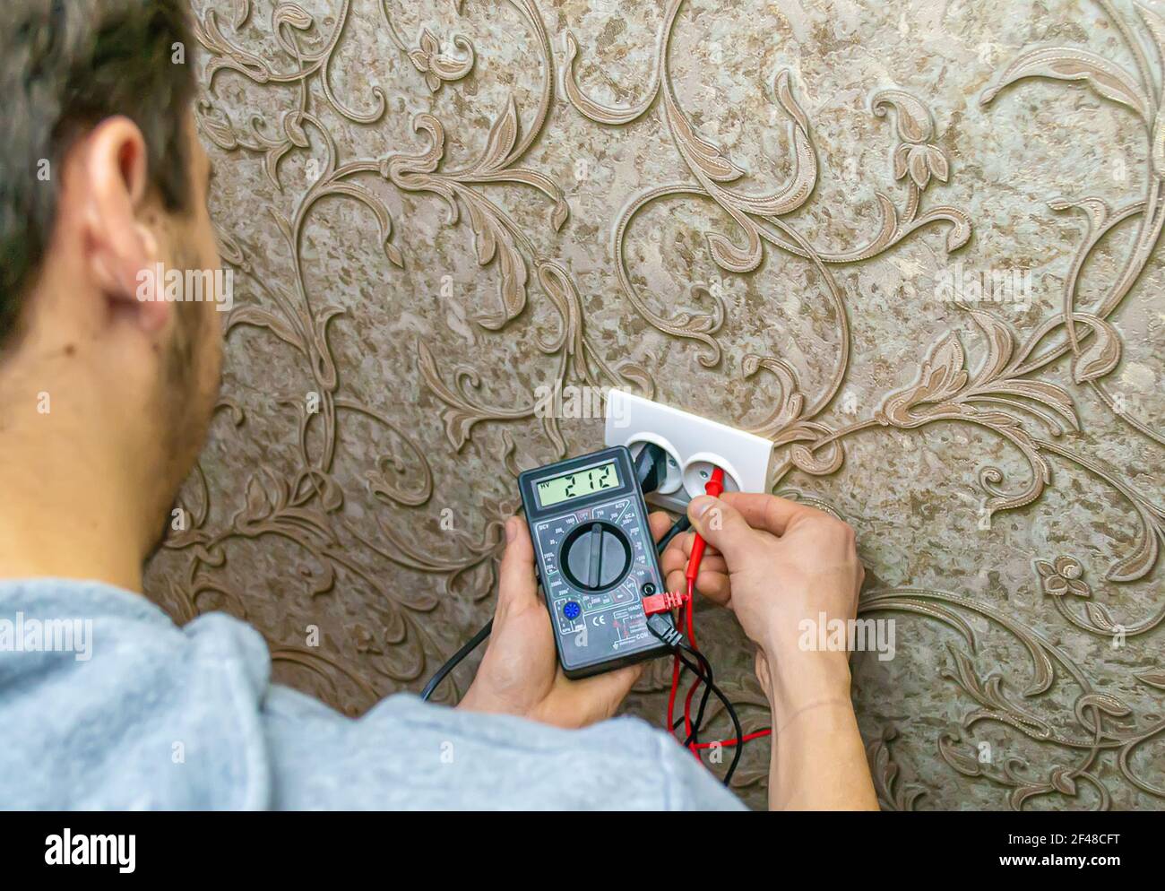 Repair of the socket, socket. Tools, voltage measuring devices. selective focus. Stock Photo