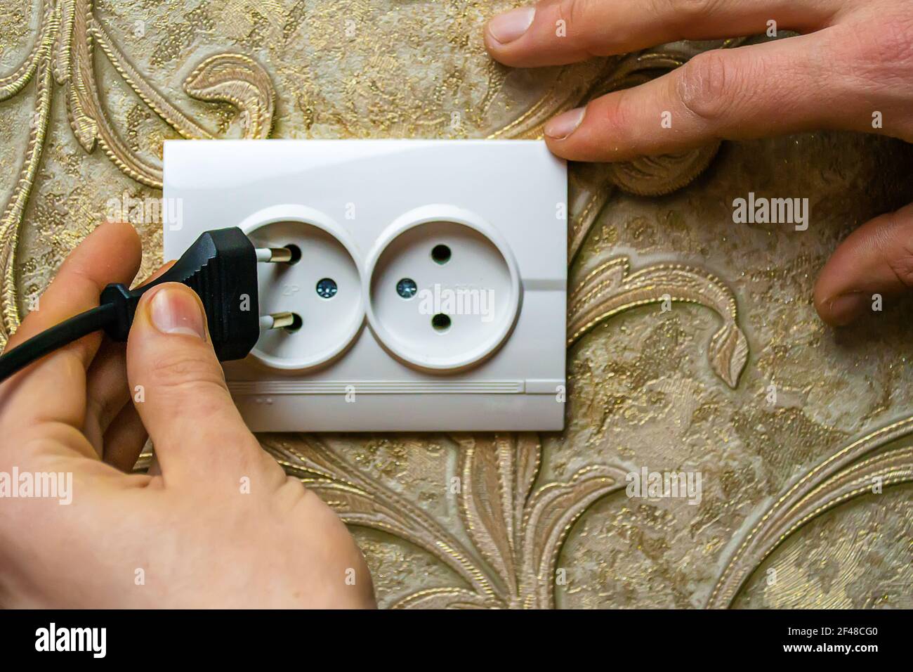 Man checking wall socket electric current hi-res stock photography and ...