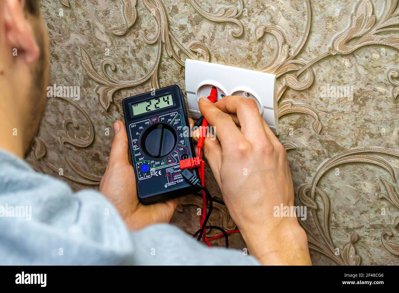 Man checking wall socket electric current hi-res stock photography and ...