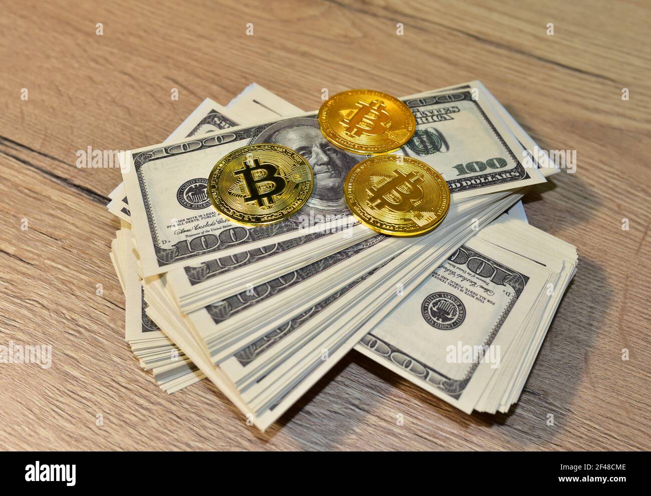Bitcoin coins on a bundle with dollars. The concept of investing money in  cryptocurrency and making a profit due to the fall in the dollar exchange  ra Stock Photo - Alamy