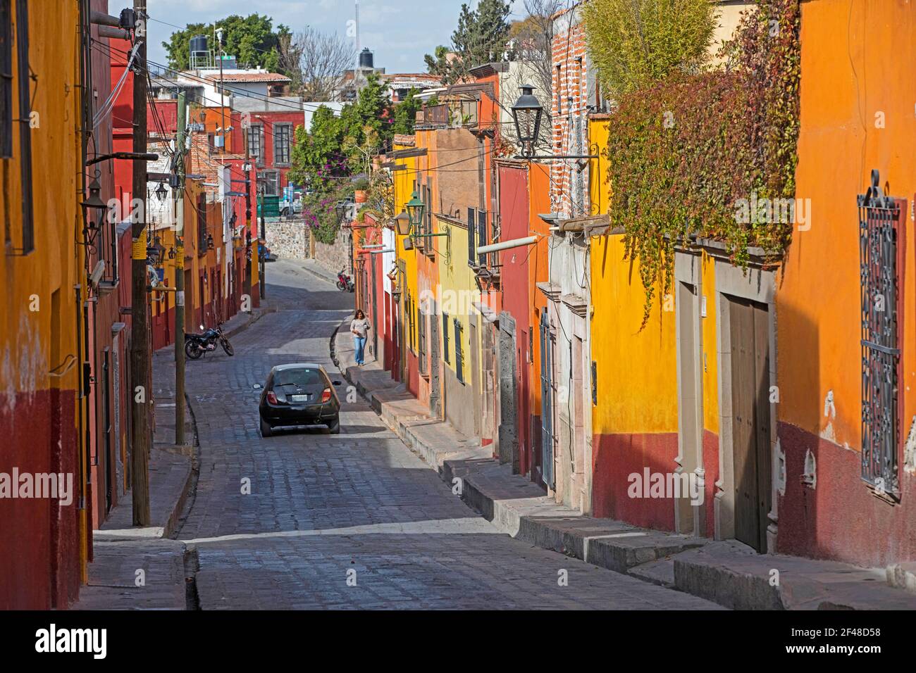 Narrow street with colourful houses in the city San Miguel de Allende, Guanajuato, Central Mexico Stock Photo
