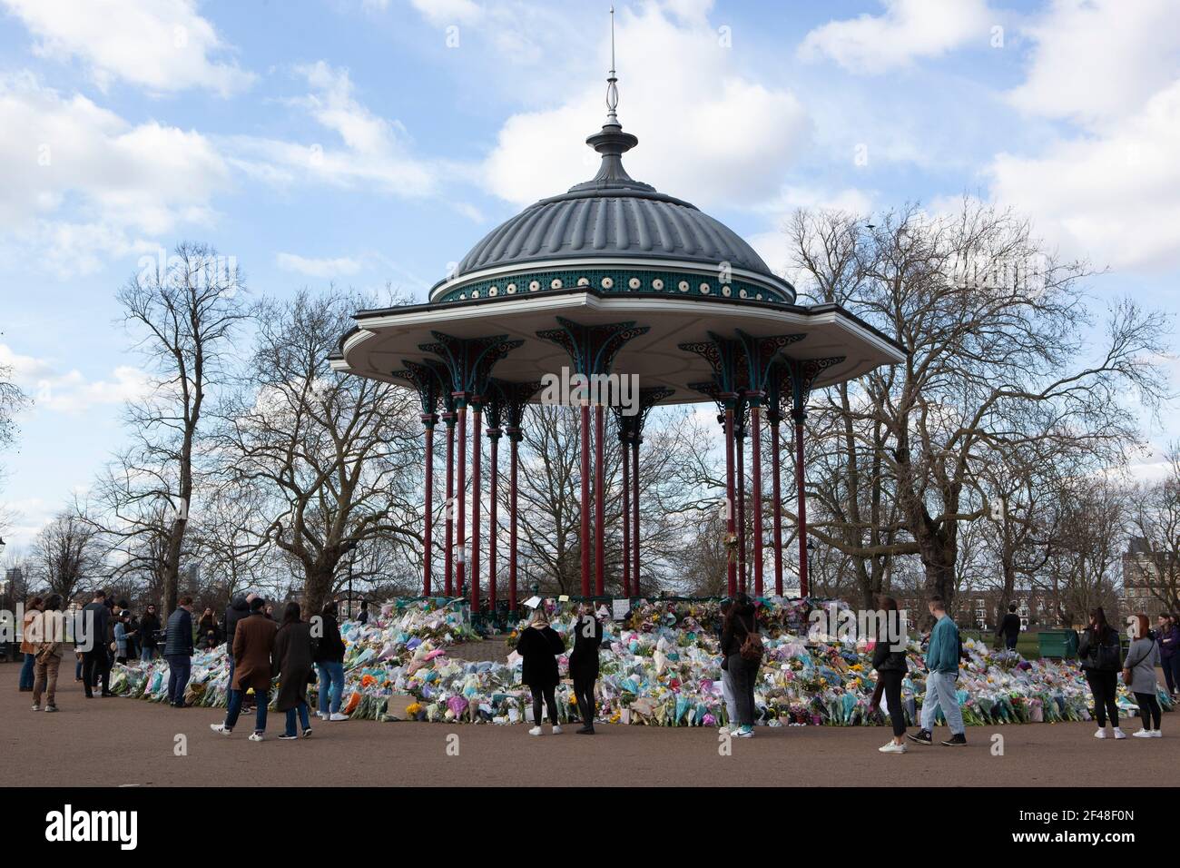 London, UK, 19 March 2021: Clapham Common bandstand and the surrounding trees and benches are home to an ever-growing shrine of flowers, candles and messages in memory of Sarah Everard. Some are personal and sad, others are angry and speak of the high numbers of women killed each year by men. Last week the Metropolitan Police broke up a vigil at the site. Anna Watson/Alamy Live News Stock Photo
