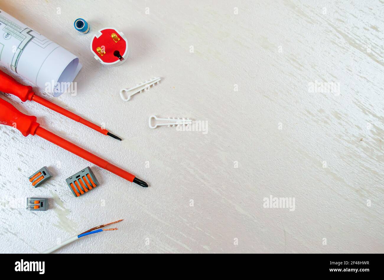 Flat composition with electrician tools on white background. Place for text. Selective focus. Stock Photo