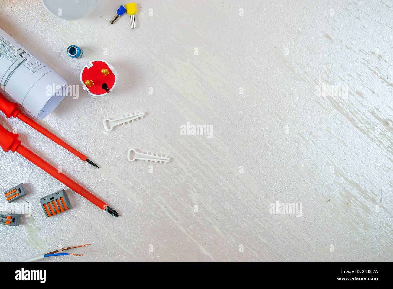 Flat composition with electrician tools on white background. Place for text. Selective focus. Stock Photo