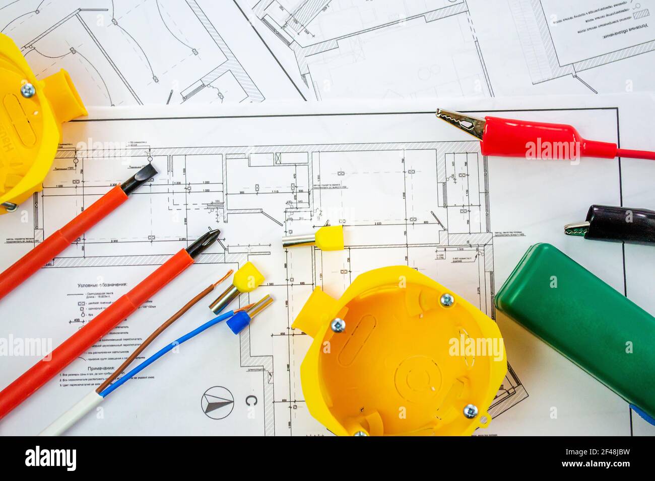 Flat lay composition with electrician's tools on house plan. Space for text.Selective focus. Stock Photo