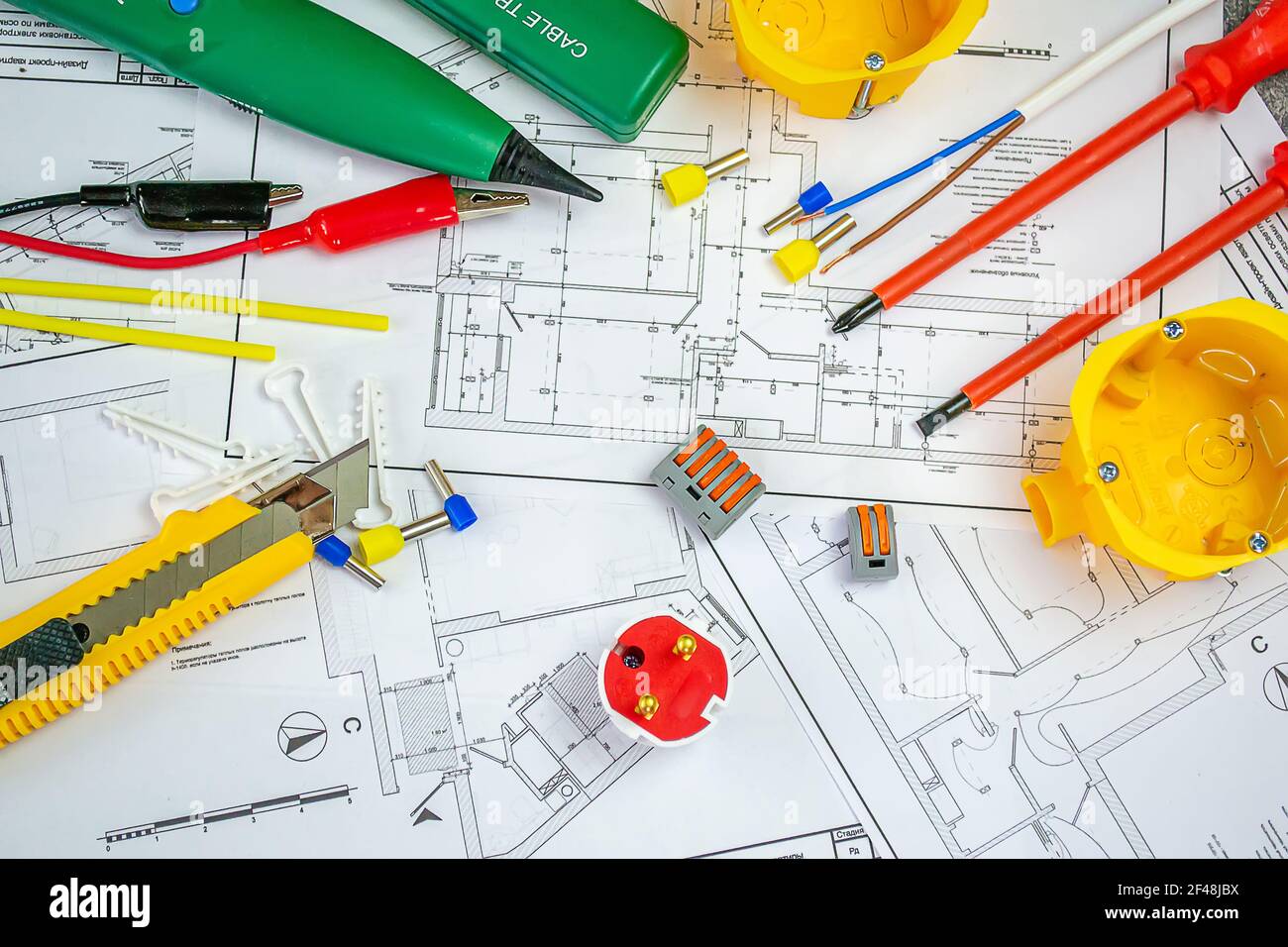 Flat lay composition with electrician's tools on house plan. Space for text.Selective focus. Stock Photo