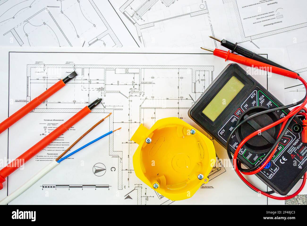 Flat lay composition with electrician's tools on house plan. Space for text.Selective focus. Stock Photo