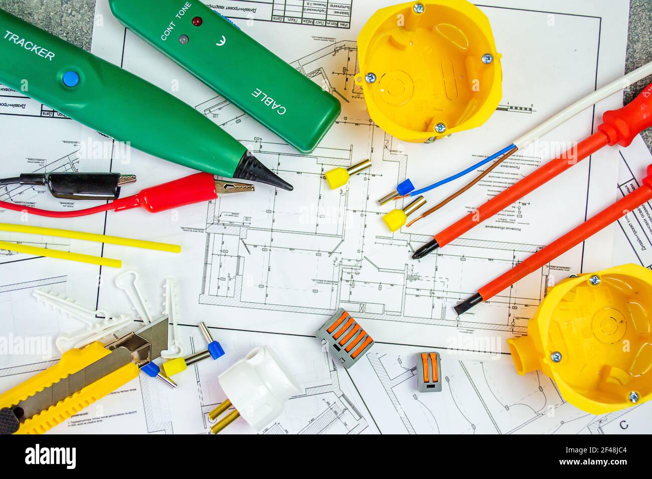 Flat lay composition with electrician's tools on house plan. Space for text.Selective focus. Stock Photo