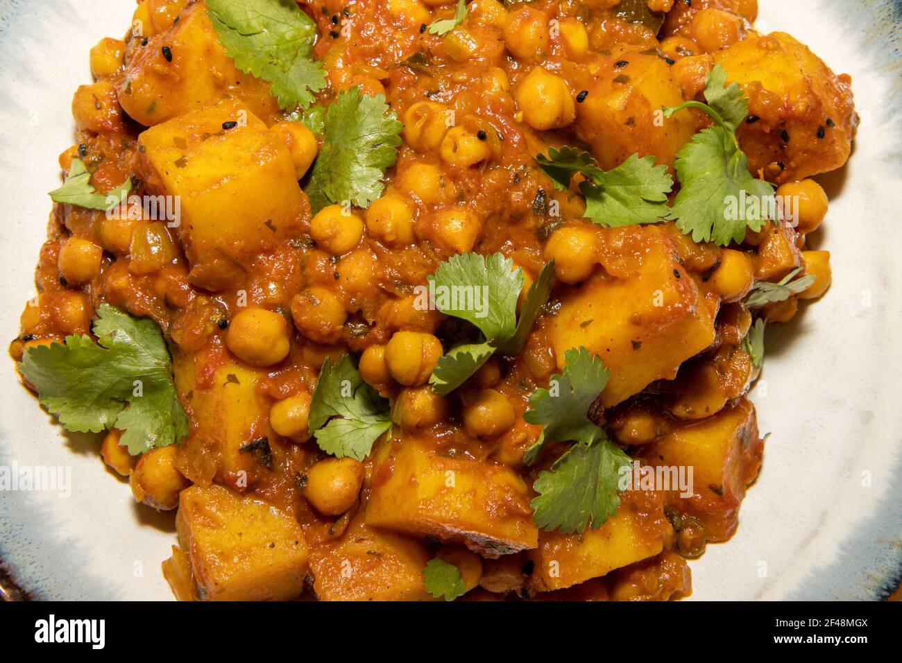A bowl of the delicious Indian dish Chana Masala made from chickpeas and potatoes Stock Photo