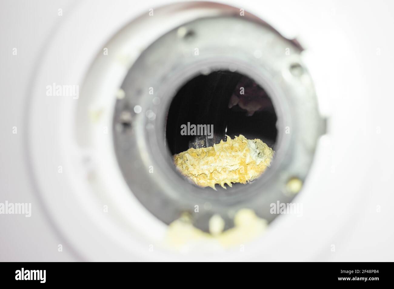 Yellow scale on the tubular electric heater of the boiler inside the tank. Dismantling and repair. Stock Photo