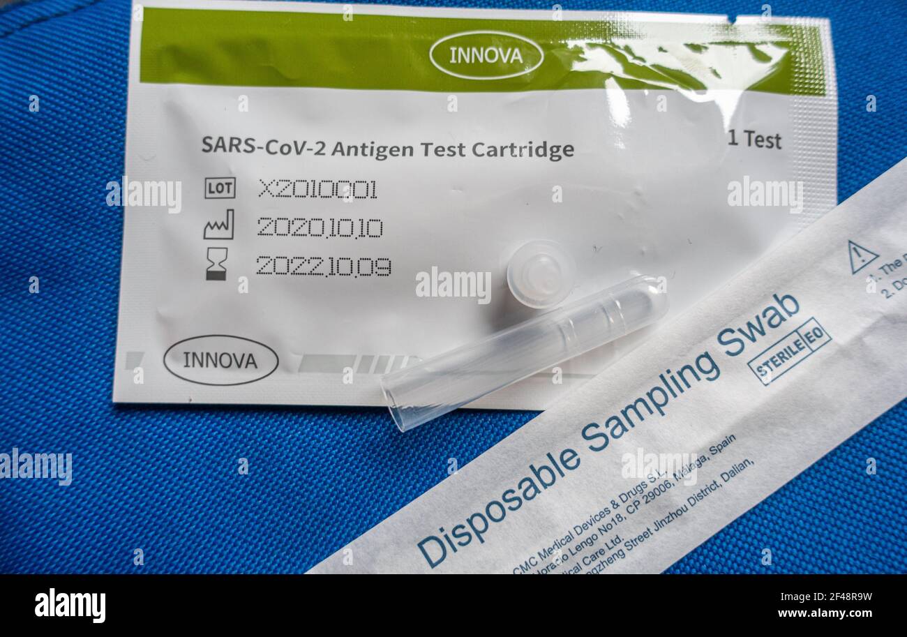 SARS-CoV-2 Antigen Test kit owned by the Innova Medical Group Inc, USA and distributed by Tried&Tested.tech, manufactured by Xiamen Biotime Biotechnology Co, Ltd. China. Coronavirus Covid 19 Lateral Flow test kit including disposable sampling swab and test cartridge, UK. On a blue fabric background. Stock Photo