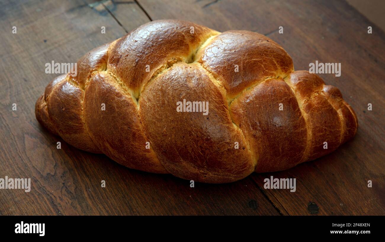Easter sweet bread, tsoureki cozonac loaf on wood table background, closeup view. Braided brioche, challah. Festive traditional religion dessert Stock Photo