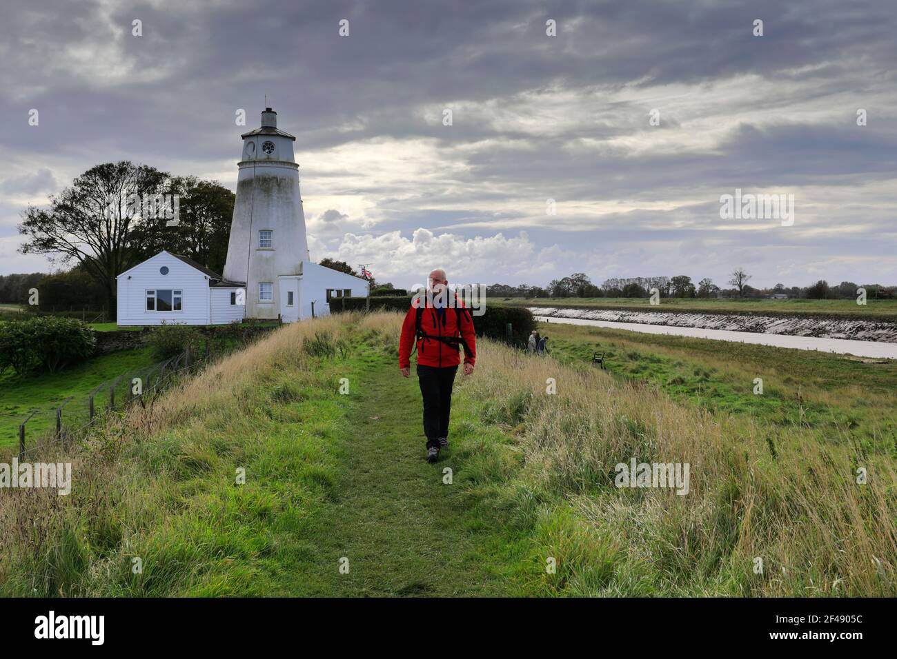 Walker at the Sir Peter Scott Lighthouse, known as the East Lighthouse, River Nene, Sutton Bridge village, South Holland district, Lincolnshire, Engla Stock Photo
