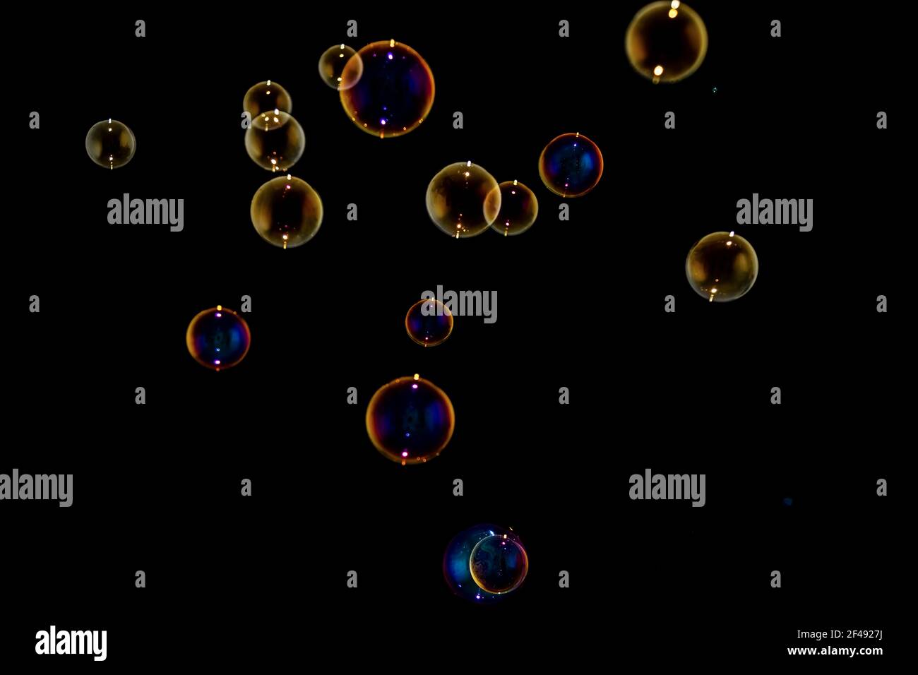 Rainbow soap bubbles on black background Stock Photo