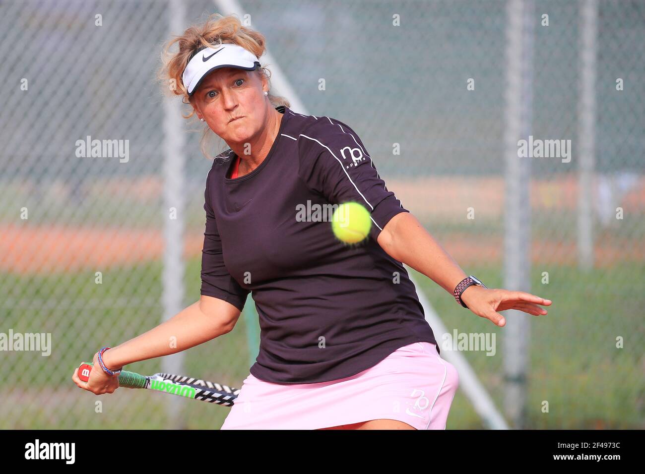 Female tennis player in action at the Munich Senior Open 2020, Women's singles WS50, ITF Seniors Tennis Tournament, Stock Photo