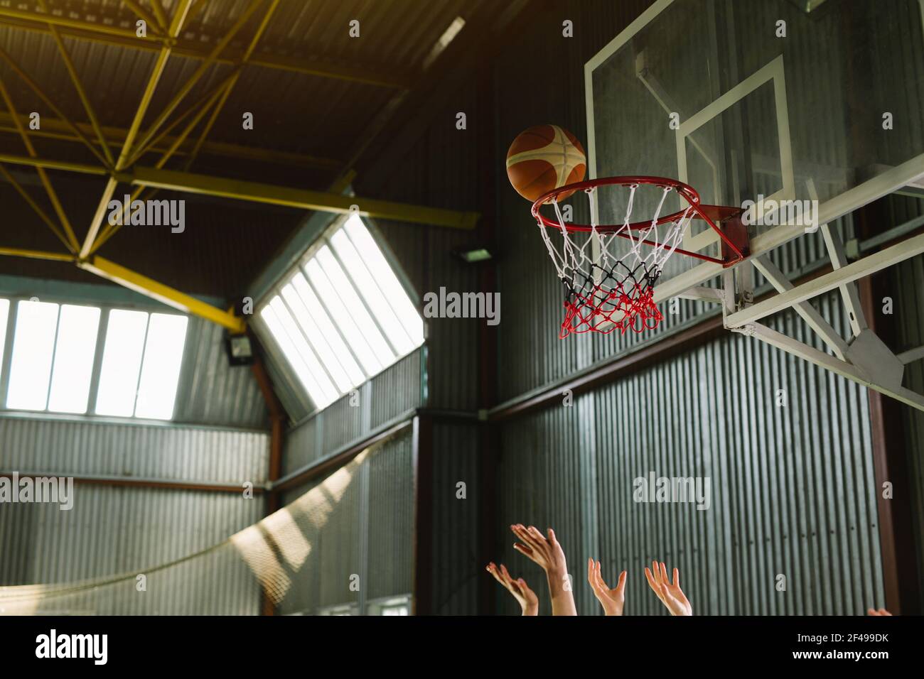 Players Hands And Ball Through Basketball Hoop Indoor Shot Sport Gym Championnat Window Sunny Light High Quality Photo Stock Photo Alamy