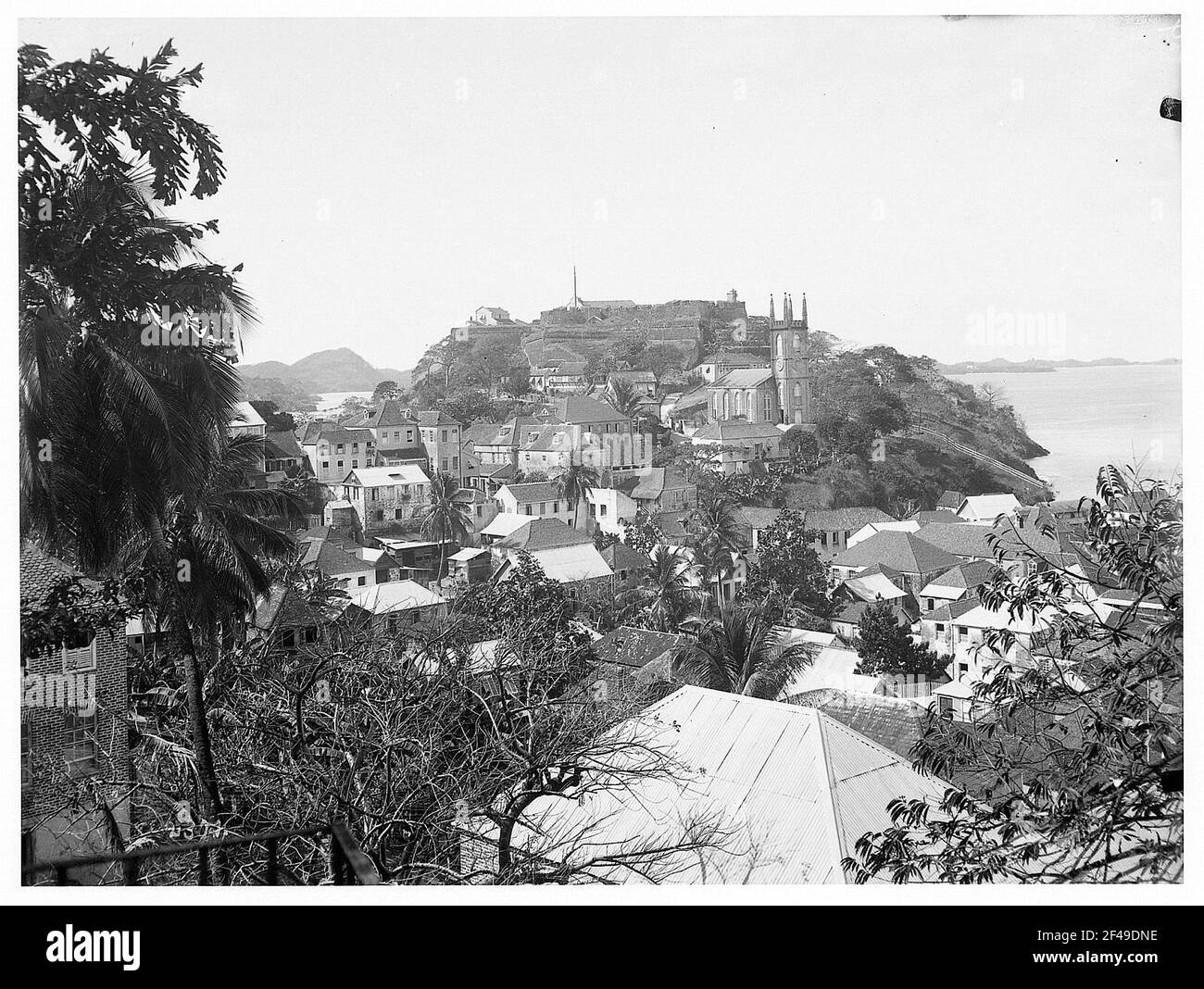 St. George, Grenada. View over houses of the city on hill with fortress and church in front of the bay Stock Photo