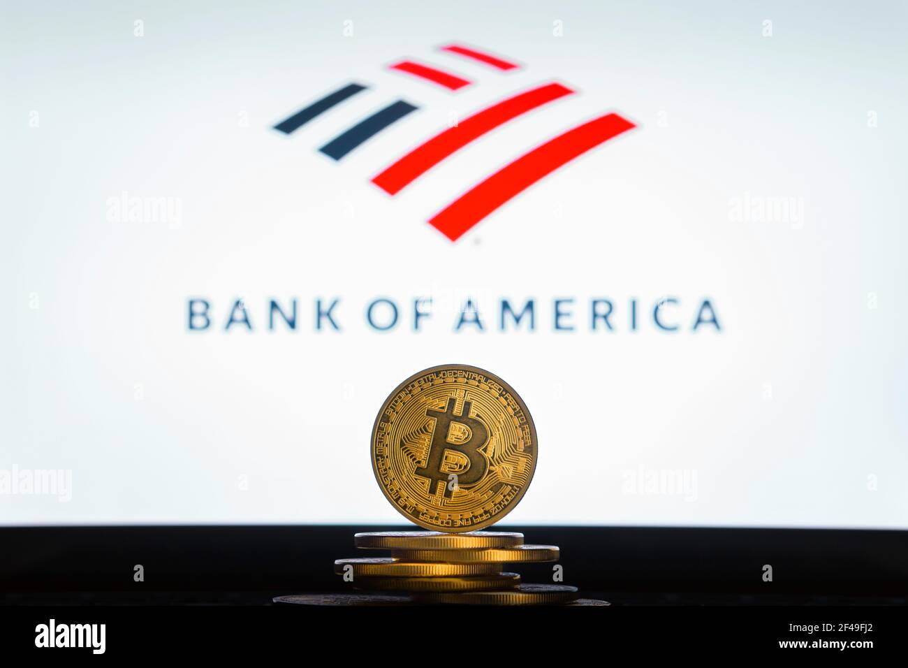 SLOVENIA, LJUBLJANA - 24 02 2019: Bitcoin on a stack of coins with Bank of America logo on a laptop screen. Stock Photo