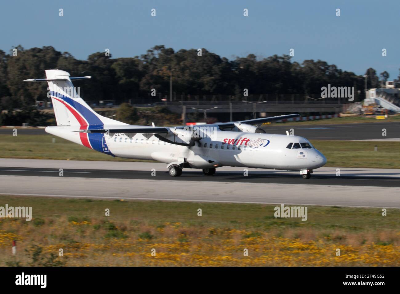 Swiftair ATR 72 propeller powered cargo plane on the runway while departing from Malta. Turboprop commercial airplane. Stock Photo