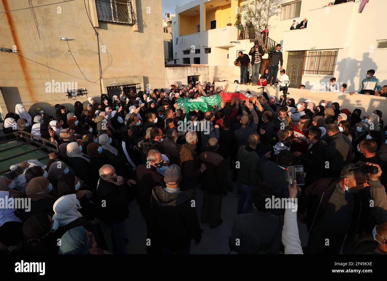 Nablus, Nablus. 19th Mar, 2021. Mourners carry the body of Palestinian Atef Yousef Hanaysha during his funeral in the West Bank village of Beit Dajan, east of Nablus, on March 19, 2021. Atef Yousef Hanaysha was shot dead by Israeli soldiers on Friday afternoon in an anti-settlement rally near Beit Dajan village, medics said. Credit: Ayman Nobani/Xinhua/Alamy Live News Stock Photo