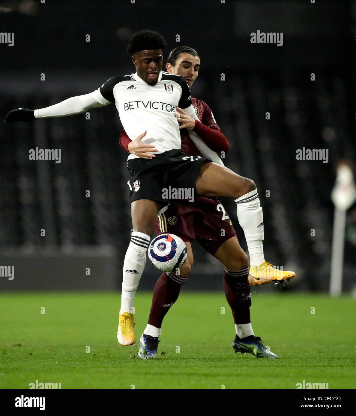 Fulham's Josh Maja (right) and Leeds United's Pascal Struijkbattle for the ball during the Premier League match at Craven Cottage, London. Picture date: Friday March 19, 2021. Stock Photo