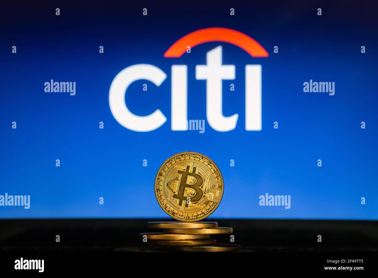 SLOVENIA, LJUBLJANA - 24 02 2019: Bitcoin on a stack of coins with Citi Bank logo on a laptop screen. Stock Photo