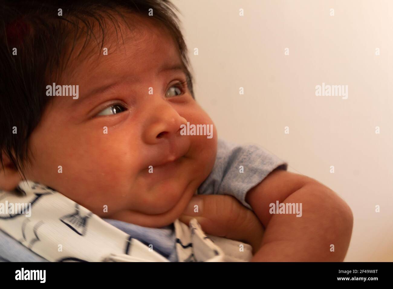beautiful portrait of a newborn hispanic baby with a funny face ...