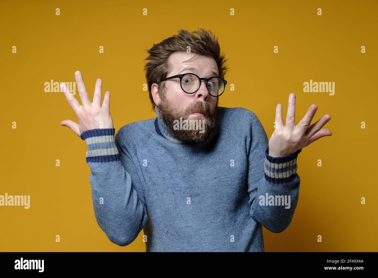 The strange, surprised man shrugs his shoulders and makes a bewildered