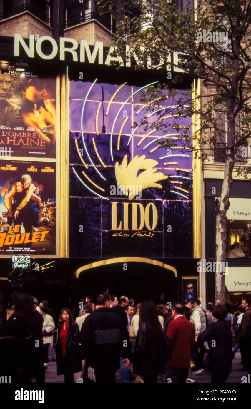 The Normandie Theater in Champs-Élysées, with people in front of it and a Lido advertisement, photographed in late 2003 Stock Photo
