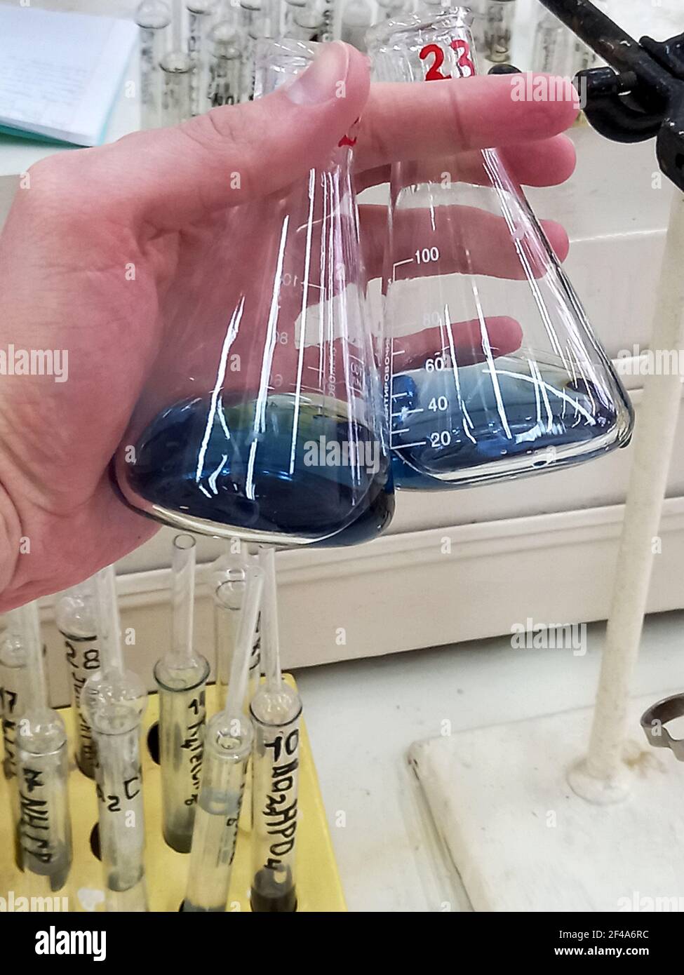 Chemical lab. Glass flasks with solutions in the hands of a laboratory