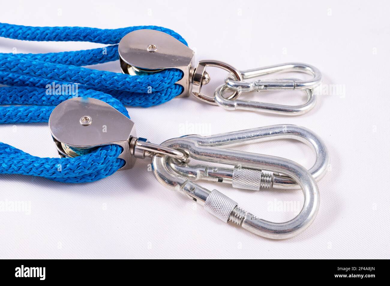Rope, carabiner and sailing pulley. Accessories used on a deep sea yacht. Light background. Stock Photo