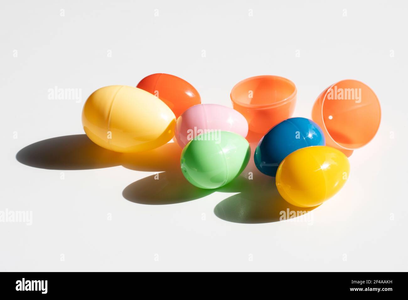 Colorful plastic Easter eggs in the sun isolated on a white background. Stock Photo