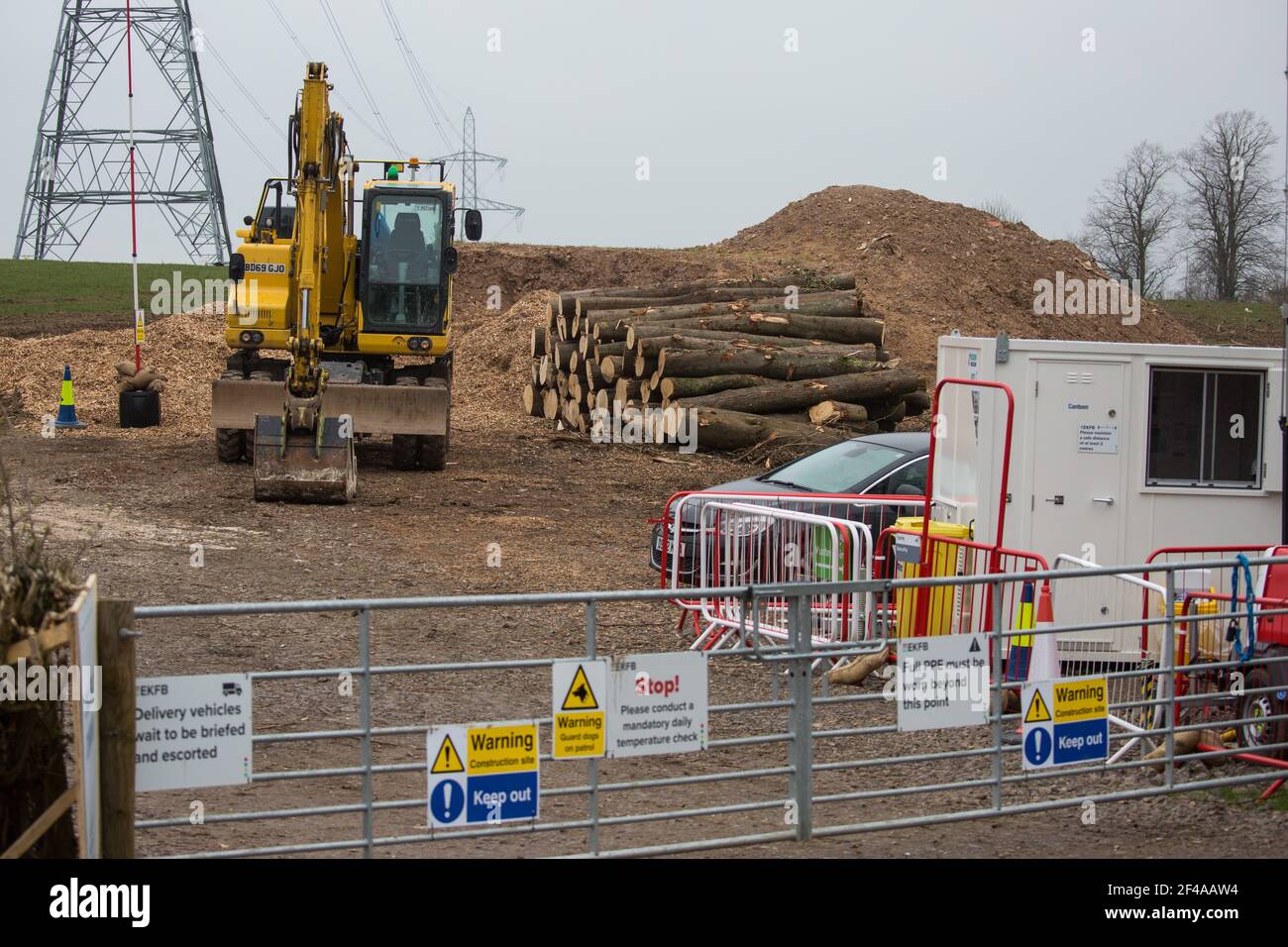 Wendover, UK. 18th March, 2021. A pile of logs from woodland felled by HS2 contractors alongside Small Dean Lane is pictured in a HS2 compound. Considerable preparatory work of this type is currently taking place between Great Missenden and Wendover to the north of the Chiltern tunnel section of the £106bn HS2 high-speed rail link. Credit: Mark Kerrison/Alamy Live News Stock Photo