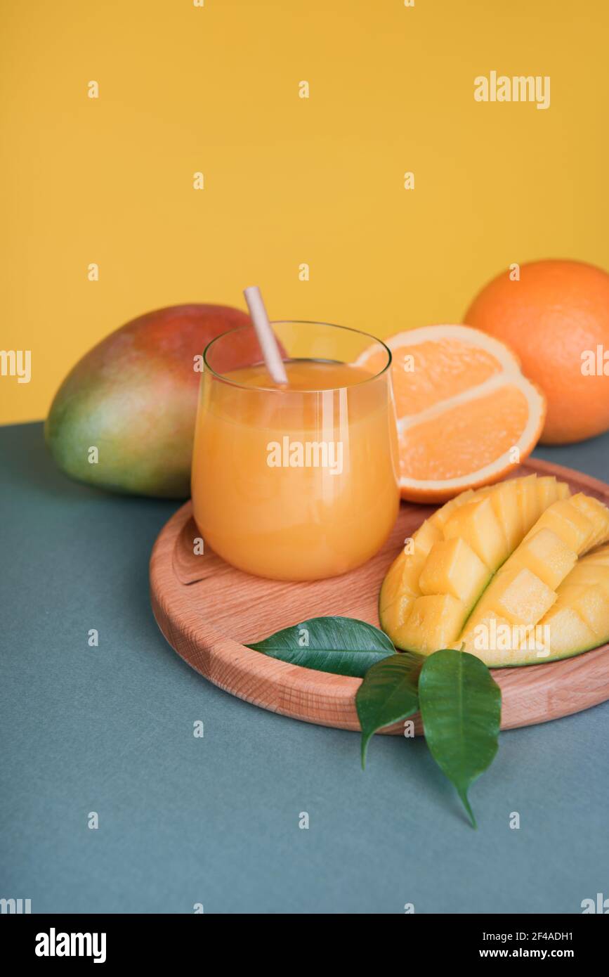 Fresh mango orange juice with ripe mangoes and orange fruit Stock Photo