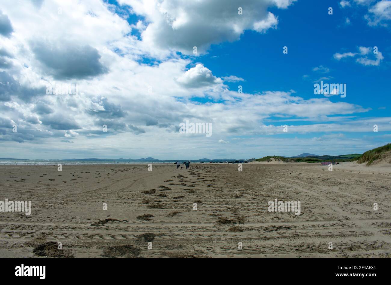 Black rock sands, Pothmadog, Wales.  Dramatic sky over broad deserted sands on a summers day. Distant mountains of Snowdonia on the horizon. Welsh sea Stock Photo