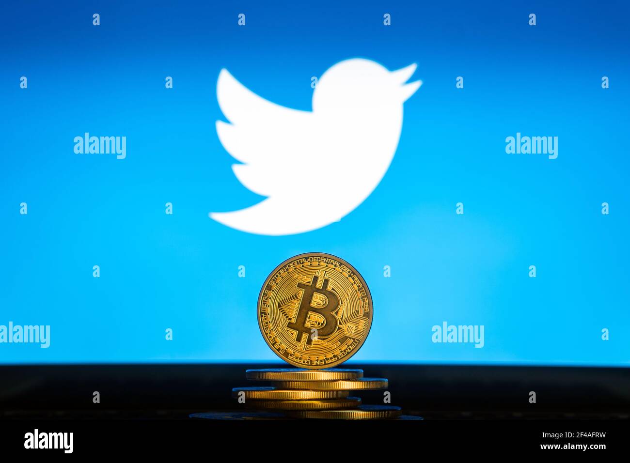 Bitcoin on a stack of coins with Twitter logo on a laptop screen. SLOVENIA, LJUBLJANA - 24 02 2019: Stock Photo