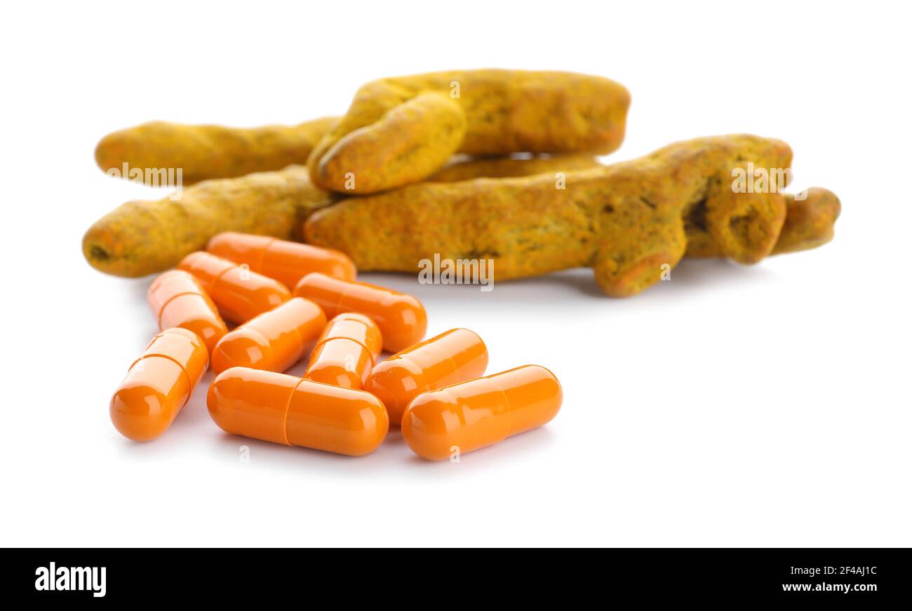 Pill The Roots Turmeric pills and roots on white background Stock Photo - Alamy