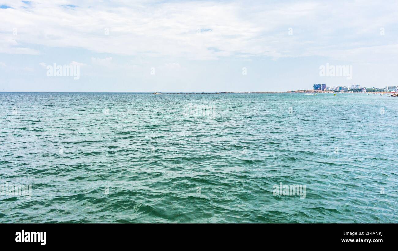 A calm sea under the cloudy sky Stock Photo - Alamy