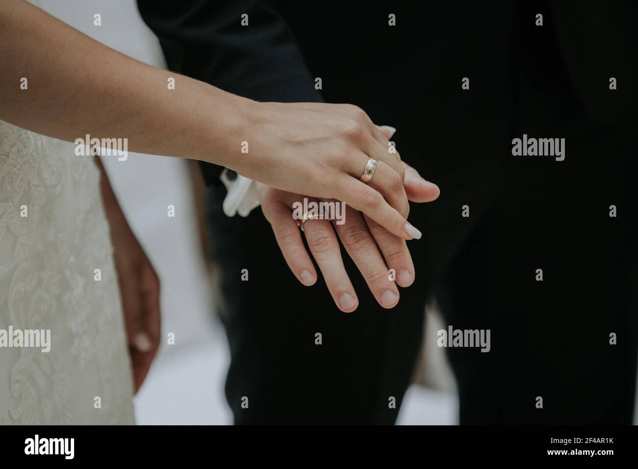 A newlywed couple holding hands Stock Photo - Alamy