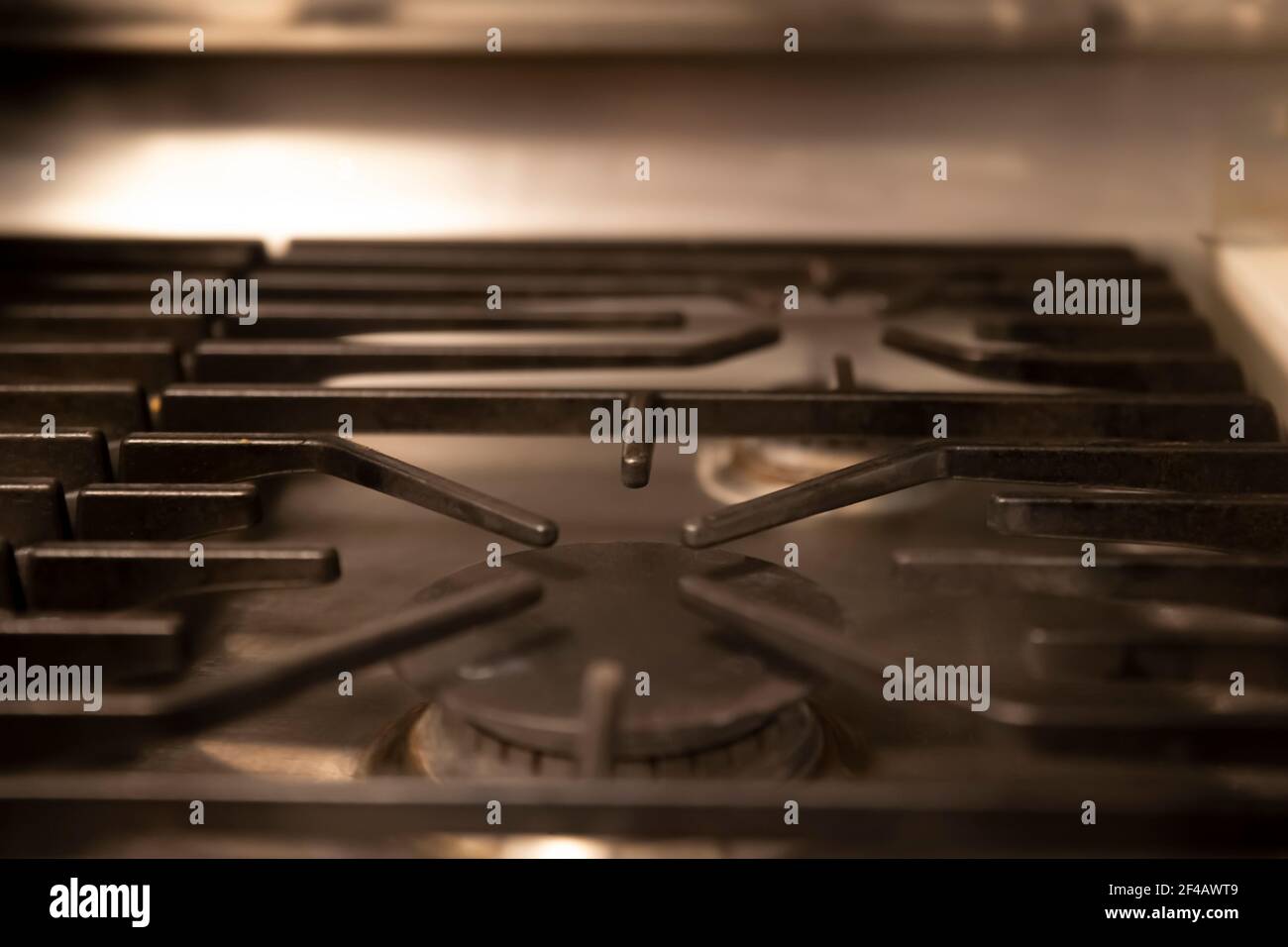 Closeup of kitchen gas stove. Gas ring burner with black steel panels