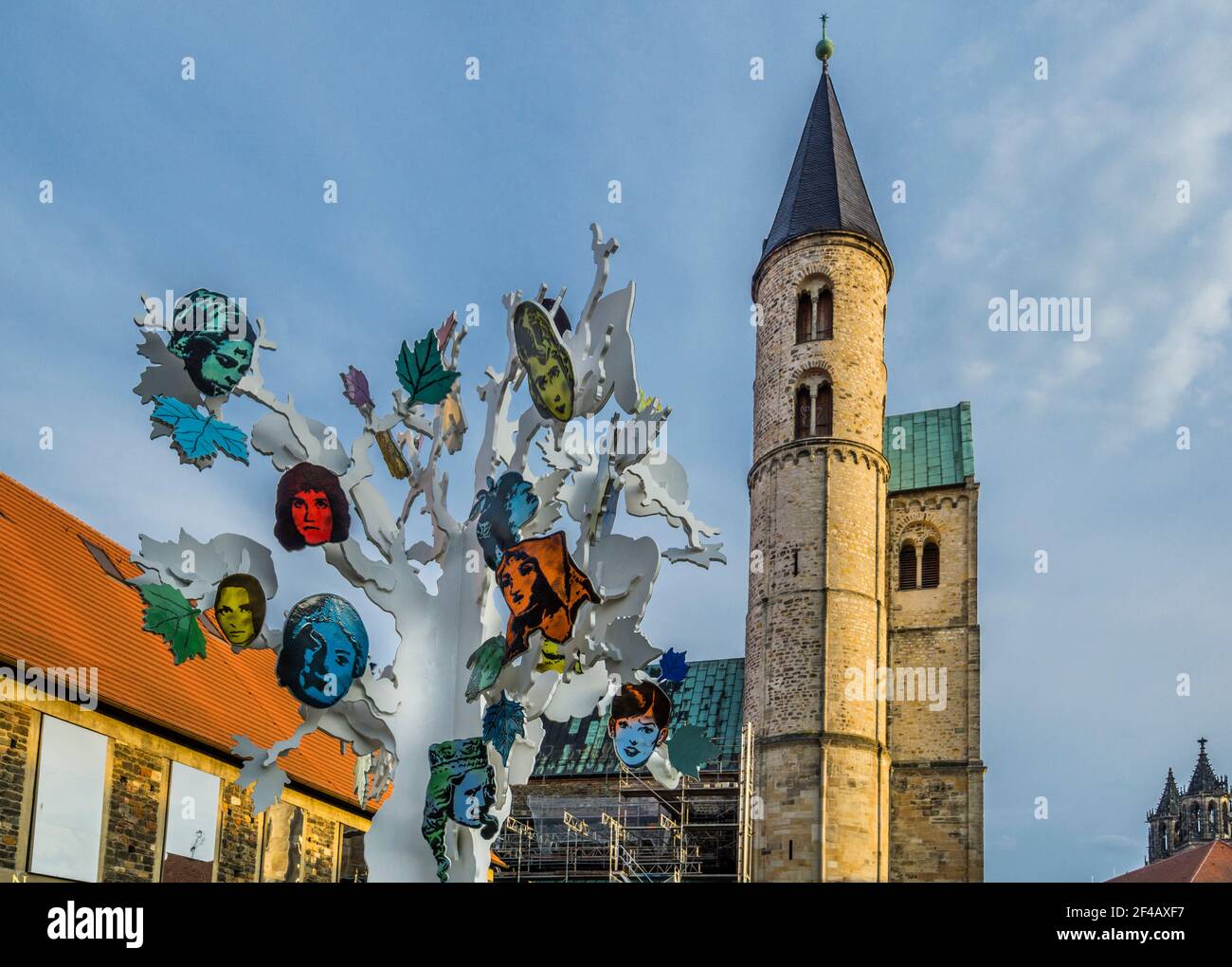 sculpture installation titled 'Island of Dolls' by Alicia Paz at sculpture park Magdeburg, against the backdrop of the Romanesque Klosterkirche, St. M Stock Photo