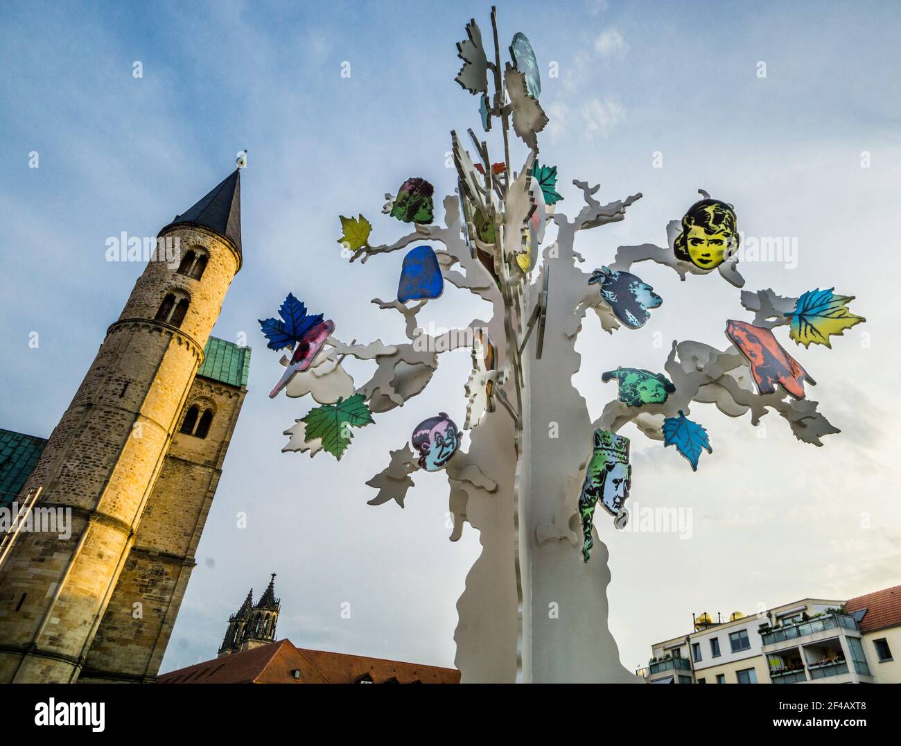 sculpture installation titled 'Island of Dolls' by Alicia Paz at sculpture park Magdeburg, against the backdrop of the Romanesque Klosterkirche, St. M Stock Photo