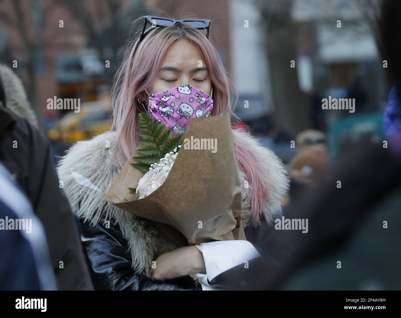New York, United States. 19th Mar, 2021. A girl holds flowers at a Vigil for Peace organized by Asian American Federation in Union Square in New York City on Friday, March 19, 2021. President Biden on Friday urged Congress to pass hate crime legislation to address the increase in discrimination and violence against Asian Americans during the COVID-19 pandemic. Photo by John Angelillo/UPI Credit: UPI/Alamy Live News Stock Photo