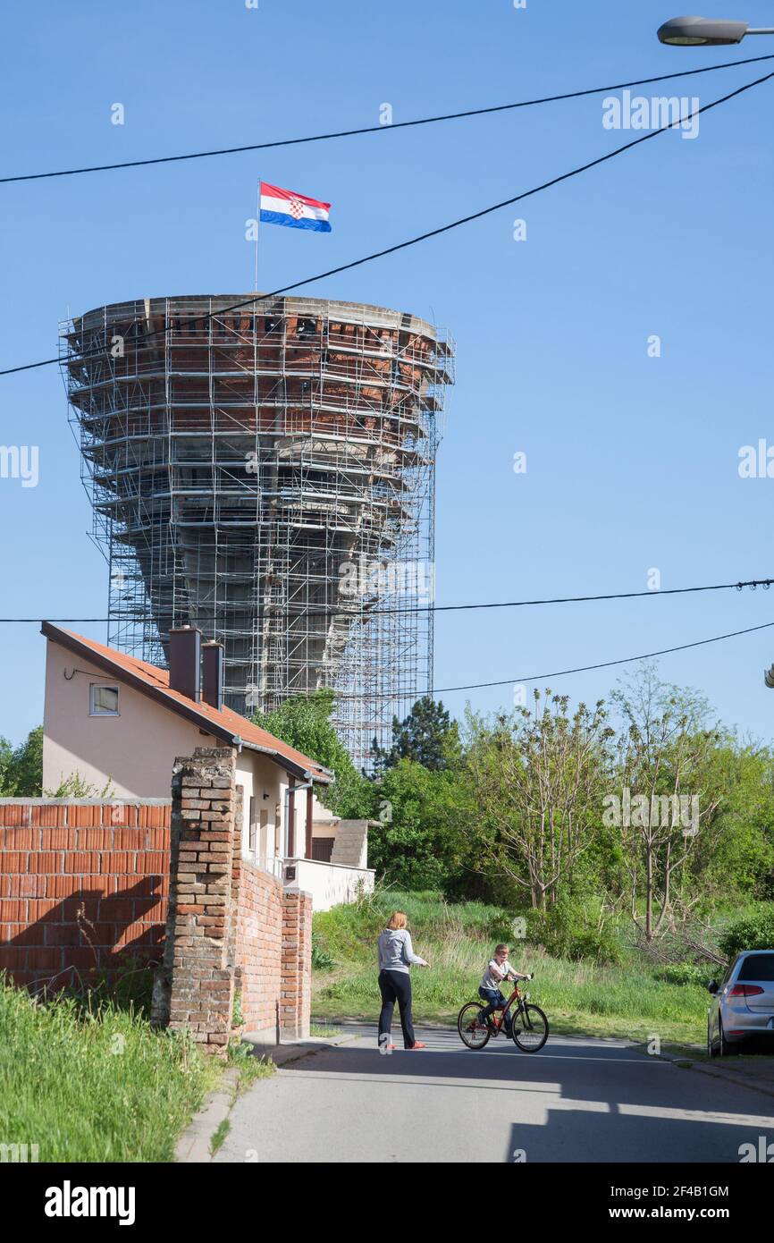 VUKOVAR, CROATIA - APRIL 20, 2018: Mother and her young child playing in Water tower, with bullet and missile holes from the 1991-1995 conflict, oppos Stock Photo