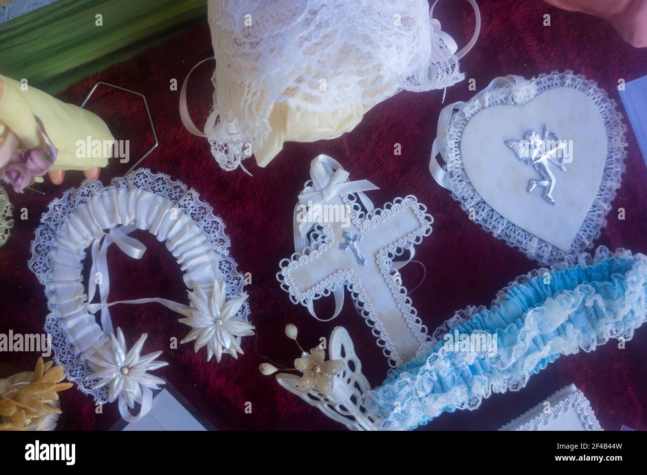 Vintage wedding items carried by brides in times gone by on display against a red velvet background at the Greenmount Heritage Fair. Stock Photo