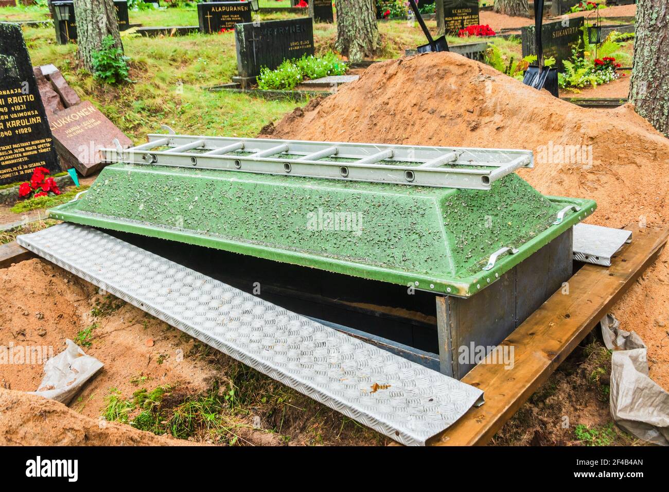 Newly dug olen grave covered with a glassfiber cover in Ylitornio Finland Stock Photo