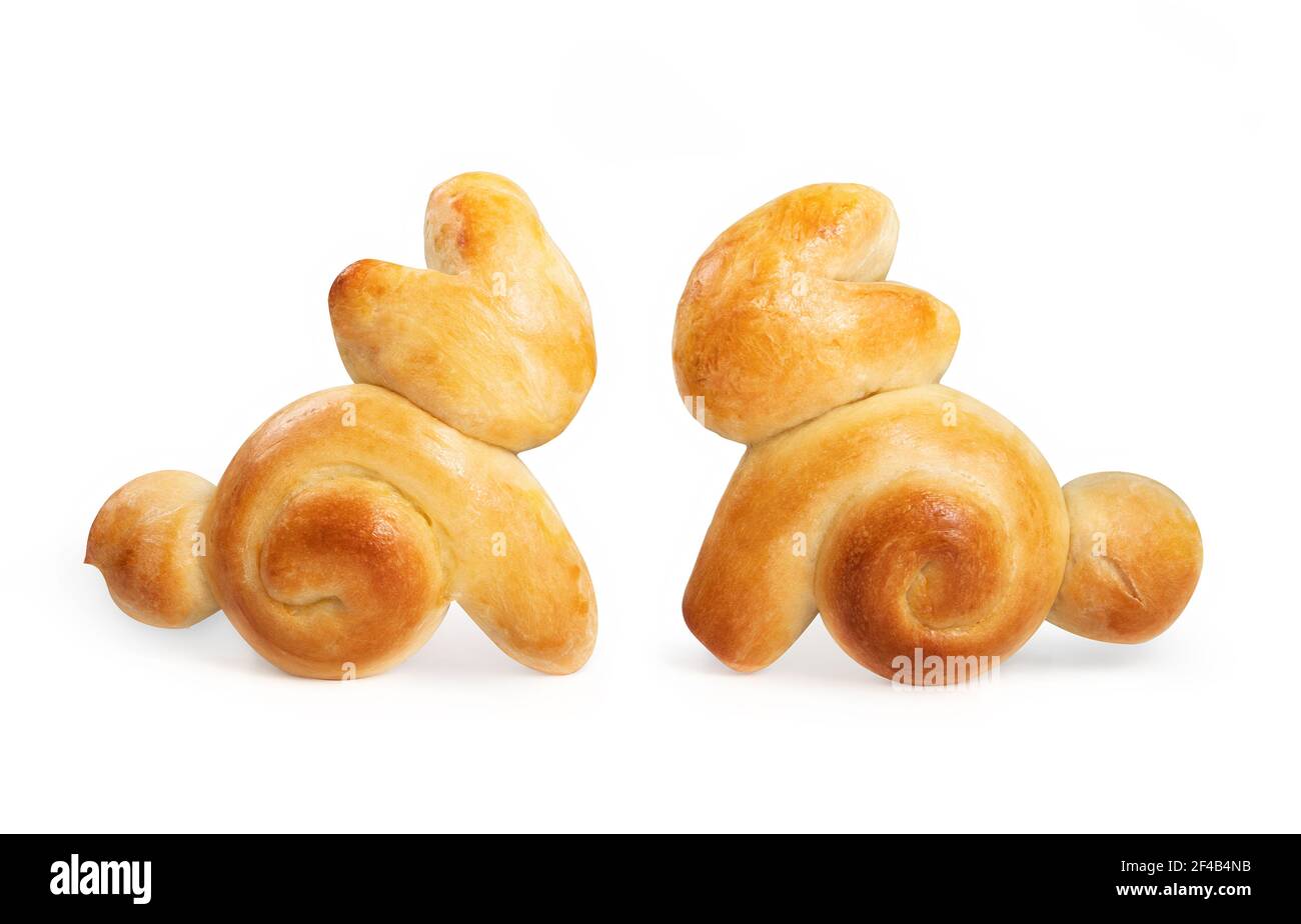 Two Easter bread bunnies. Adorable rabbit shaped yeast bread buns. Home made edible decoration for Easter holiday family table. Swiss butter bread rec Stock Photo