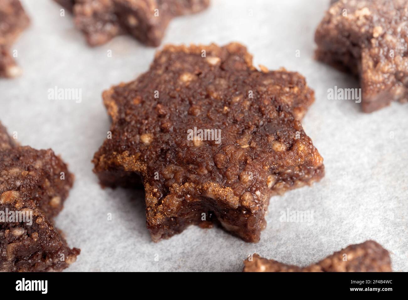 Gluten free almond flour and chocolate cookie in shape of a star with sugar cinnamon rim, ready to be baked. Swiss recipe 'Basler Brunsli'. GF Christm Stock Photo